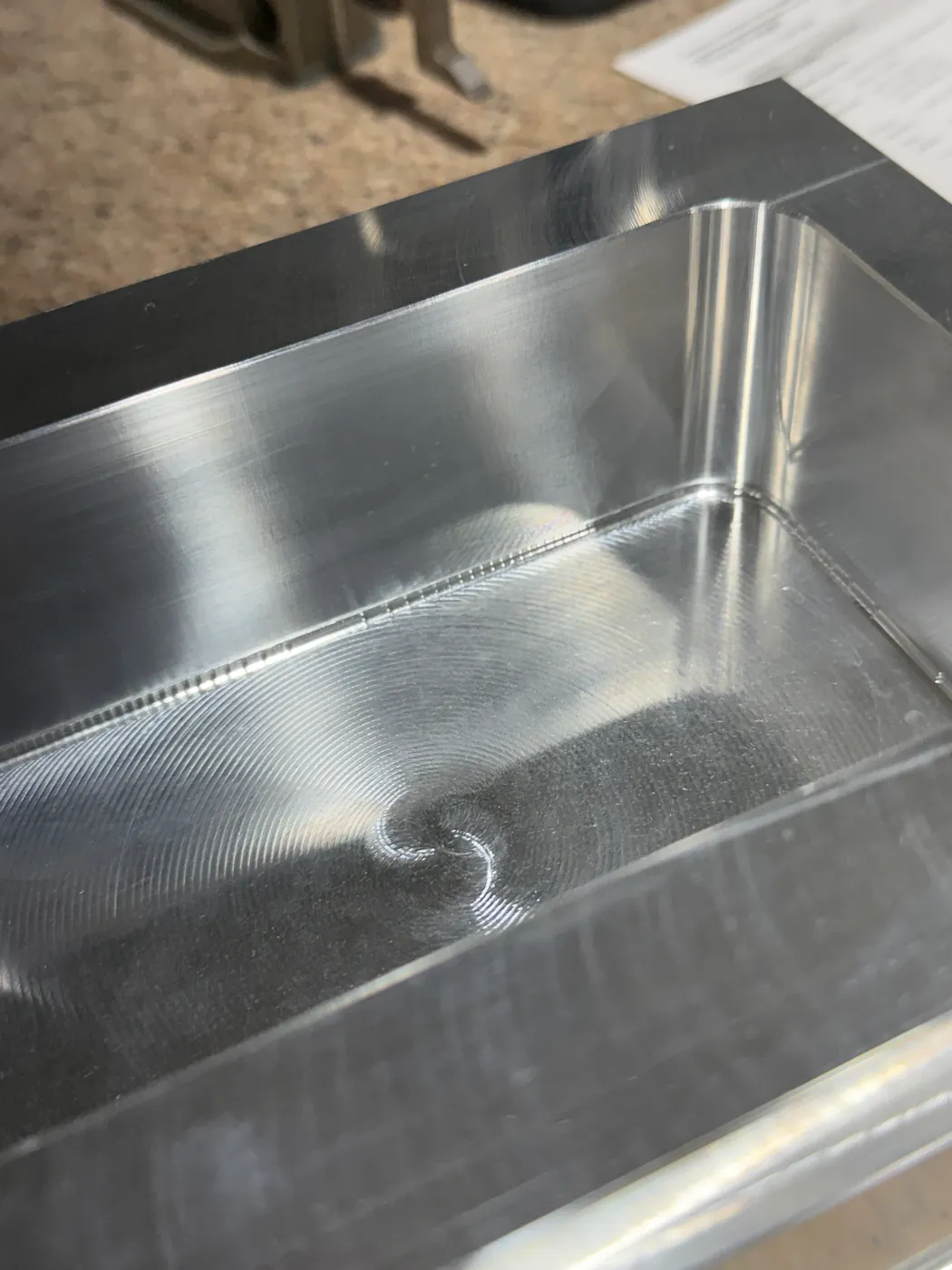 Close view of a machined pocket floor with a fine spiral finish